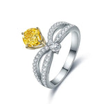 Load image into Gallery viewer, Elegant silver ring featuring a yellow diamond and intricate bow-like design with smaller diamonds.
