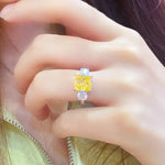 Load image into Gallery viewer, Yellow diamond ring with smaller white diamonds on either side.
