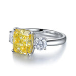 Load image into Gallery viewer, Silver ring featuring a square-cut yellow gemstone flanked by two round white diamonds.
