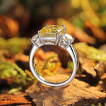 Load image into Gallery viewer, Silver engagement ring with a square yellow diamond center stone and two smaller side diamonds.
