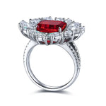 Load image into Gallery viewer, Ornate silver ring featuring a prominent square-cut ruby surrounded by diamonds.
