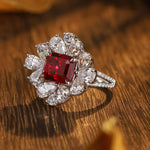 Load image into Gallery viewer, Ornate diamond ring featuring a square-cut ruby center stone surrounded by pear-shaped diamonds.
