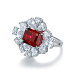 Load image into Gallery viewer, Ornate ring featuring a square-cut ruby surrounded by pear-shaped diamonds.
