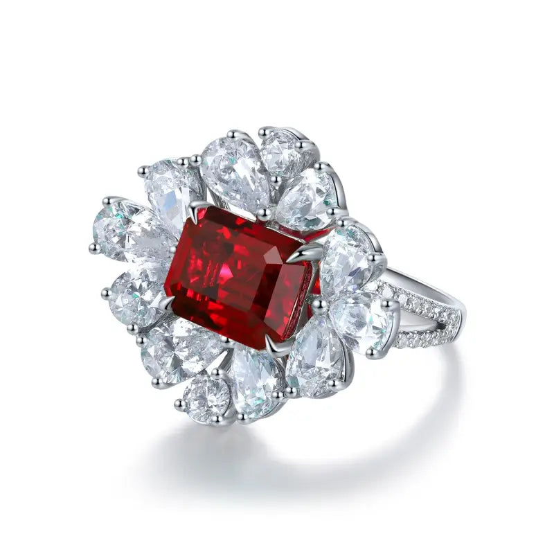 Ornate ring featuring a square-cut ruby surrounded by pear-shaped diamonds.