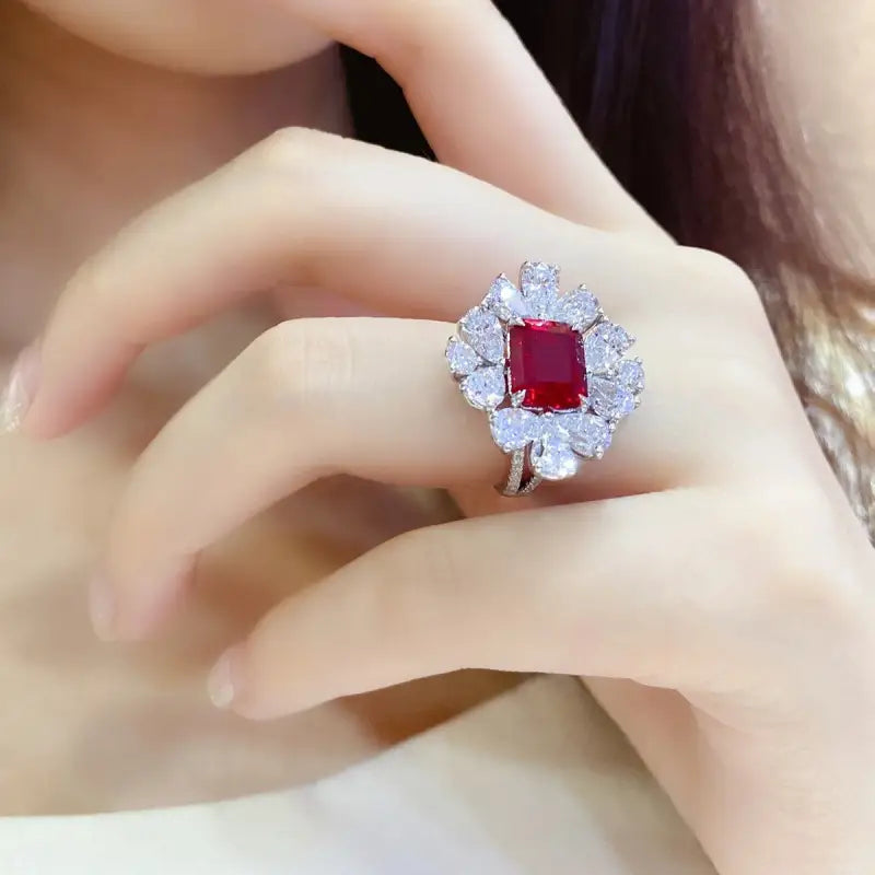 Ornate ring featuring a square-cut ruby surrounded by diamonds.