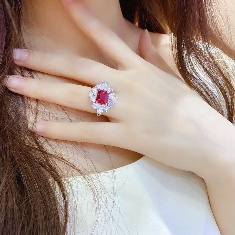 Ruby and diamond ring on a woman’s finger.