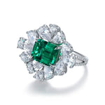 Load image into Gallery viewer, Ornate ring featuring a square emerald surrounded by pear-shaped diamonds.
