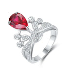 Load image into Gallery viewer, Ornate silver ring featuring a pear-shaped red gemstone and small diamond accents.
