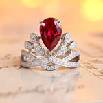 Load image into Gallery viewer, Ornate silver ring featuring a pear-shaped red gemstone and diamond accents.
