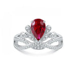 Load image into Gallery viewer, Ornate silver ring featuring a pear-shaped ruby surrounded by diamond accents.
