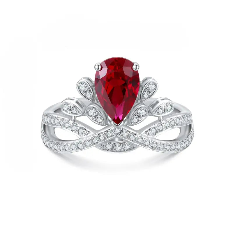 Ornate silver ring featuring a pear-shaped ruby surrounded by diamond accents.