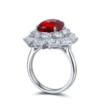 Load image into Gallery viewer, Ornate silver ring featuring a prominent heart-shaped red gemstone surrounded by clear diamonds.
