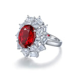 Load image into Gallery viewer, Ornate silver ring featuring a large oval ruby surrounded by diamond accents.
