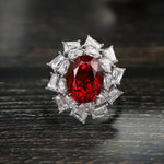 Load image into Gallery viewer, Ornate ring featuring a vibrant red gemstone surrounded by clear diamonds.
