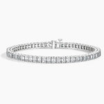 Load image into Gallery viewer, Diamond tennis bracelet with emerald-cut stones set in a white metal.
