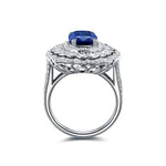 Load image into Gallery viewer, Ornate silver ring featuring a central blue gemstone surrounded by diamonds.
