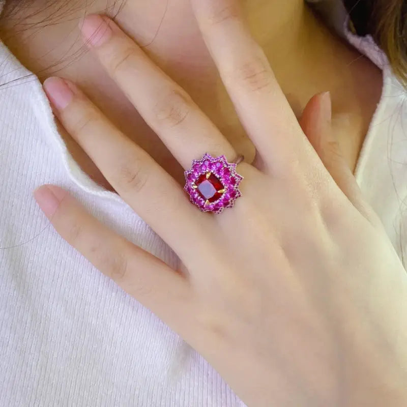 Ornate pink gemstone ring with a floral-like design.