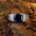 Load image into Gallery viewer, Silver ring with a square-cut deep blue gemstone.
