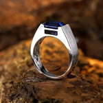 Load image into Gallery viewer, Silver ring with a square-cut blue gemstone.
