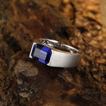 Load image into Gallery viewer, Silver ring with a rectangular blue gemstone.
