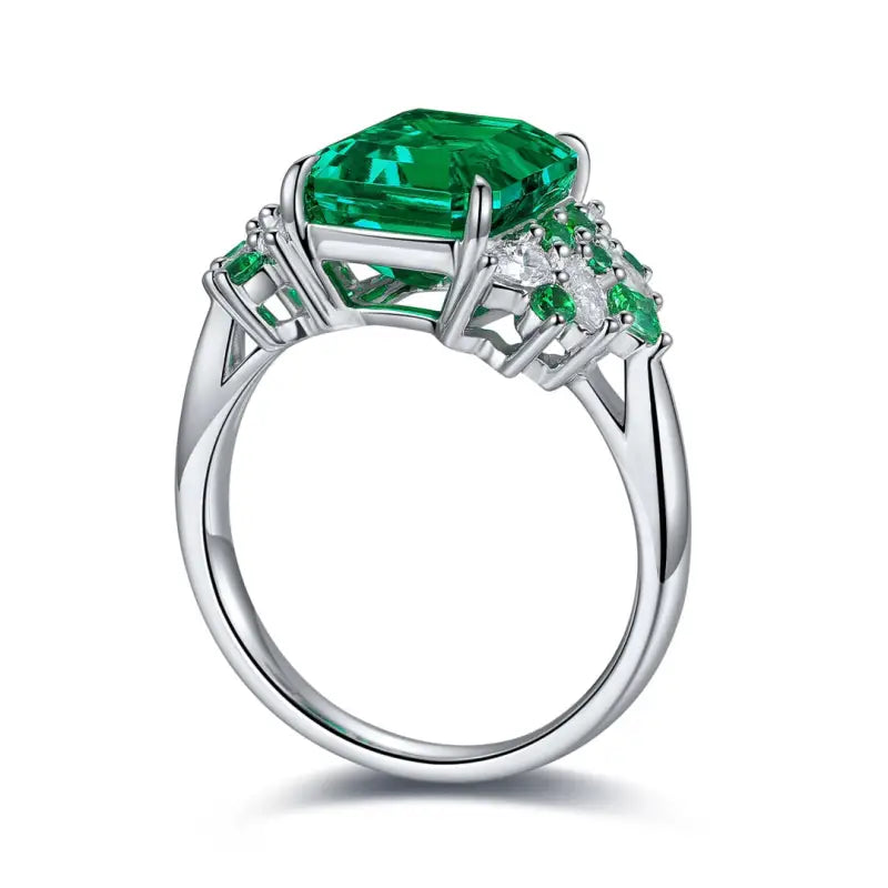 Emerald and diamond ring with a silver band.