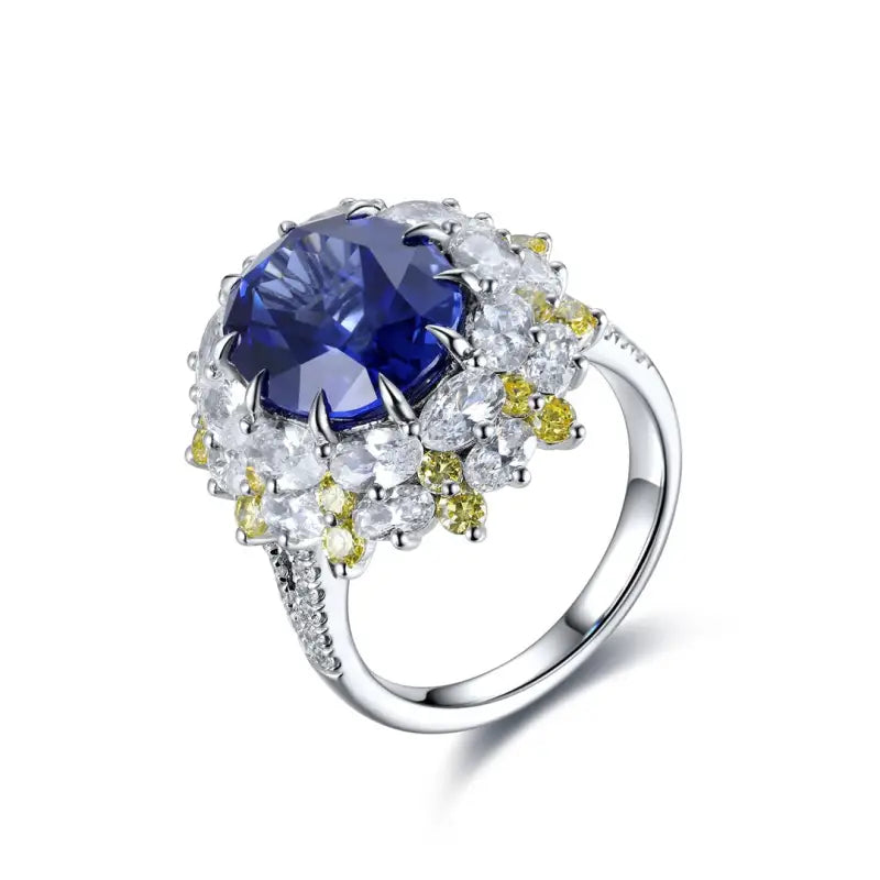 Ornate silver ring featuring a prominent blue gemstone surrounded by smaller white and yellow stones.