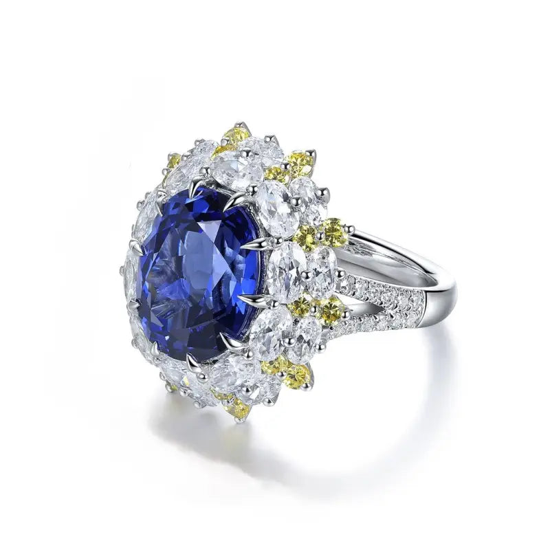 Ornate silver ring featuring a prominent oval blue gemstone surrounded by smaller white and yellow stones.