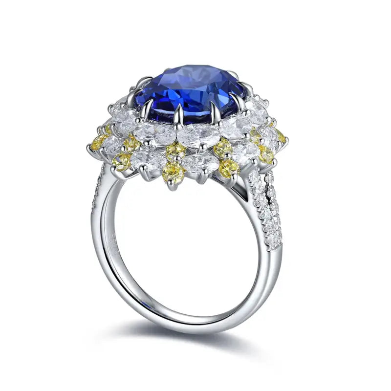 Ornate silver ring featuring a prominent blue gemstone surrounded by smaller white and yellow diamonds.