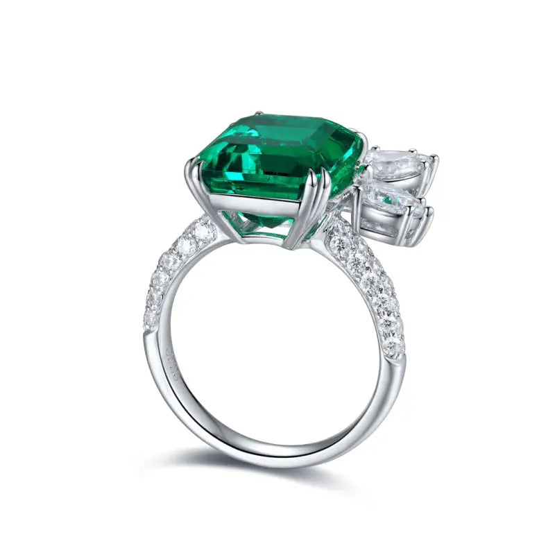 Emerald and diamond ring with a silver band.