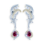 Load image into Gallery viewer, Pair of ornate feather-shaped earrings with dangling ruby-colored gemstones.
