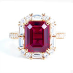 Load image into Gallery viewer, Ornate gold ring featuring a prominent emerald-cut ruby surrounded by diamonds.
