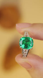 Load and play video in Gallery viewer, 3.5 Ct Cushion Shape Lab Emerald Four Prongs Graduating Pave Engagement Ring
