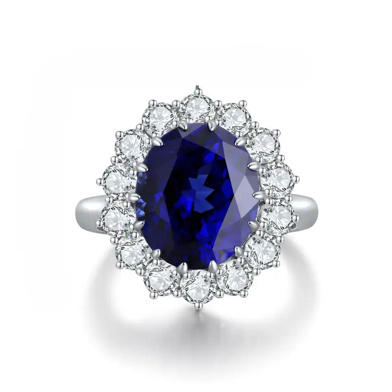 Sapphire and diamond ring with an oval-cut center stone surrounded by a halo of round diamonds.