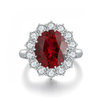 Load image into Gallery viewer, Ornate ring featuring a deep red oval gemstone surrounded by smaller clear stones.
