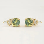 Load image into Gallery viewer, Pair of gold stud earrings featuring green gemstones and small diamonds.
