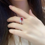 Load image into Gallery viewer, Ruby and diamond ring on a person’s finger.
