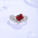 Load image into Gallery viewer, Elegant ring featuring a rectangular red gemstone surrounded by small diamonds.
