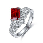 Load image into Gallery viewer, Silver ring featuring a rectangular red gemstone and diamond accents.
