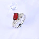 Load image into Gallery viewer, Silver ring featuring a rectangular red gemstone and small white diamonds.
