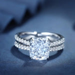 Load image into Gallery viewer, Diamond engagement ring with a cushion-cut center stone and double pavé band.
