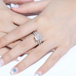 Load image into Gallery viewer, Diamond engagement ring on a woman’s finger.
