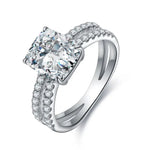 Load image into Gallery viewer, Diamond engagement ring with a prominent cushion-cut center stone and pave-set diamond band.
