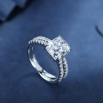 Load image into Gallery viewer, Diamond engagement ring with a cushion-cut center stone and pave-set band.
