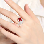 Load image into Gallery viewer, Elegant ring featuring a teardrop-shaped red gemstone surrounded by diamond accents.
