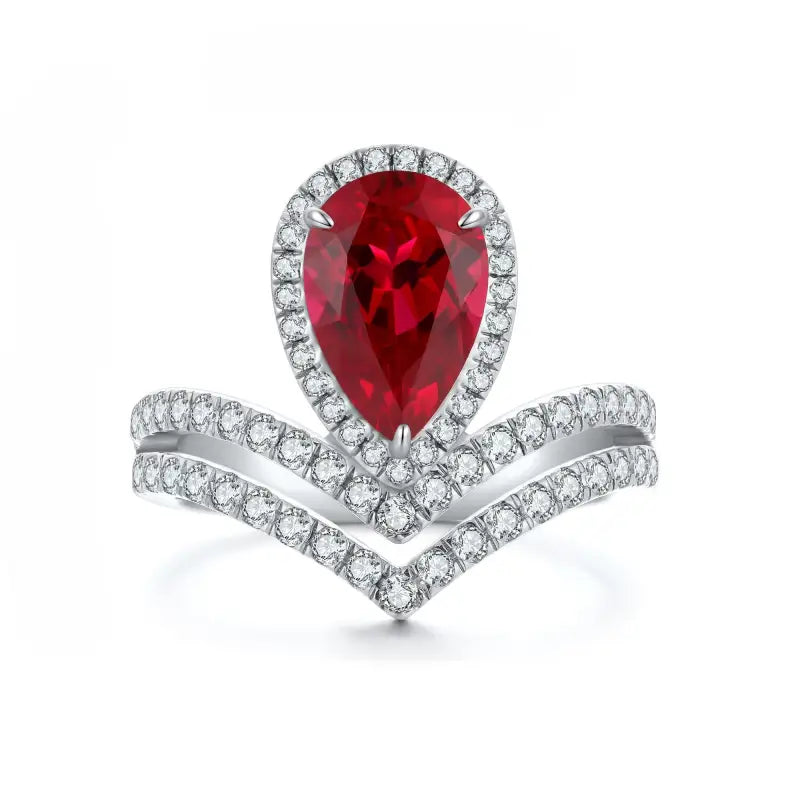 Elegant ring featuring a pear-shaped ruby surrounded by diamonds in a chevron setting.