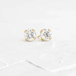 Load image into Gallery viewer, Pair of diamond stud earrings set in gold.
