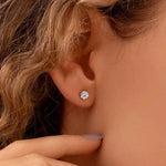 Load image into Gallery viewer, Diamond stud earring in a person’s earlobe.
