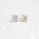 Load image into Gallery viewer, Diamond stud earrings set in gold prongs.
